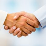 Business handshake closing a deal at the office