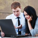 Young couple with laptop.
